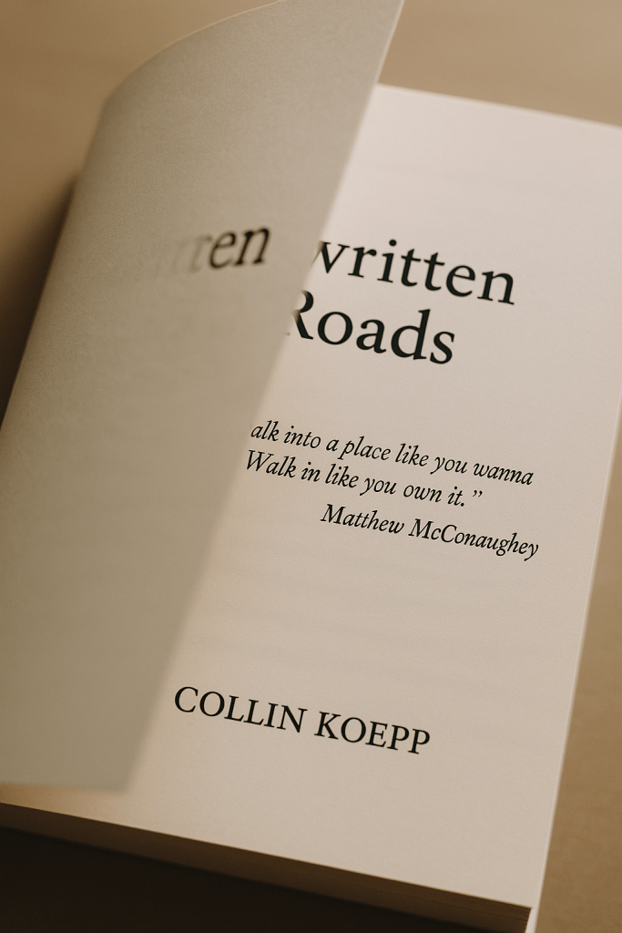 Close-up of an open book titled 'Unwritten Roads' by Collin Koepp, with a quote by Matthew McConaughey visible on the page.